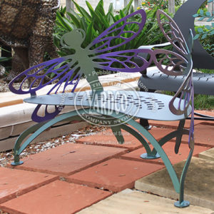 Front view of a multicolored, purple and green Steel Hand Forged Dragonfly Bench