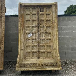 Antique Indian teak door, 94 inches tall, showcasing intricate carvings and a rich, warm finish.