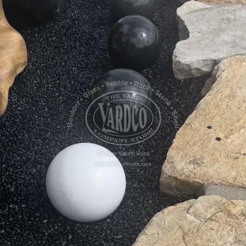 Black and white marble sphere with bold veining and a polished surface.