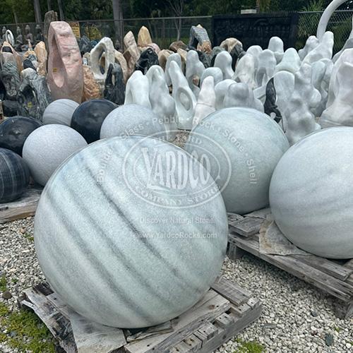 Glossy black, white and gray marble spheres with unique veining details.
