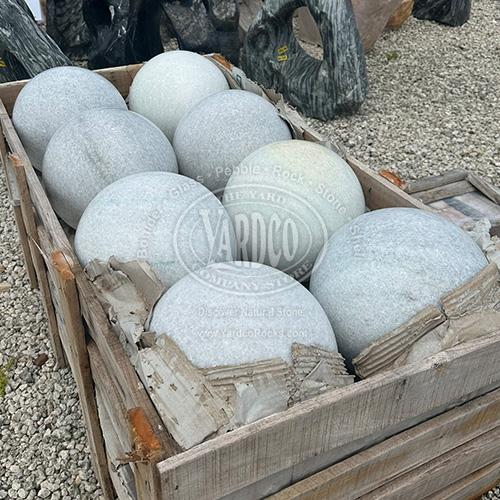 Smooth white and gray marble sphere with intricate natural patterns.